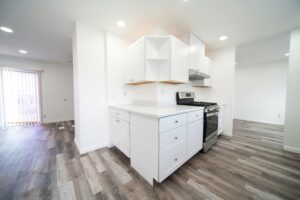 a kitchen with white cabinets and a stove