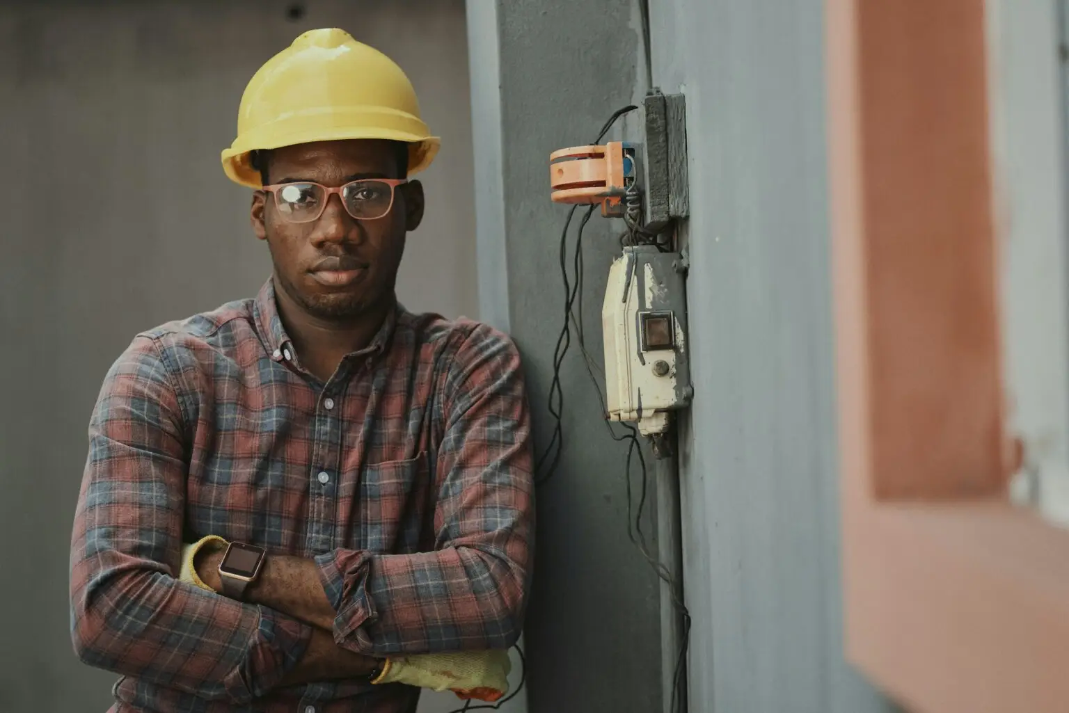 a man wearing a hard hat and glasses
