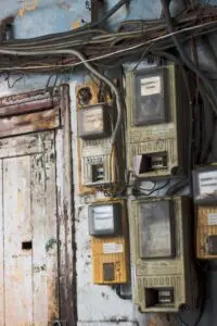 a group of electrical meters on a wall