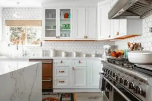 a kitchen with white cabinets and white countertops