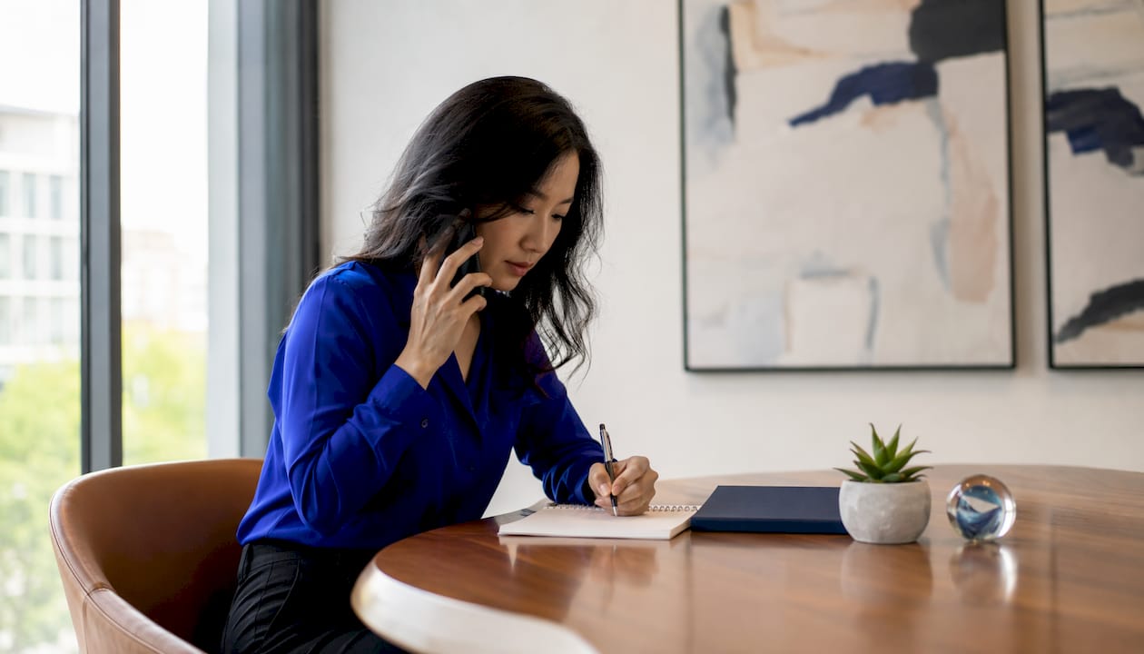 Woman scheduling commercial inspection on phone