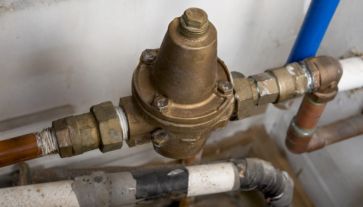 Close-up of pressure regulating valve on water pipe
