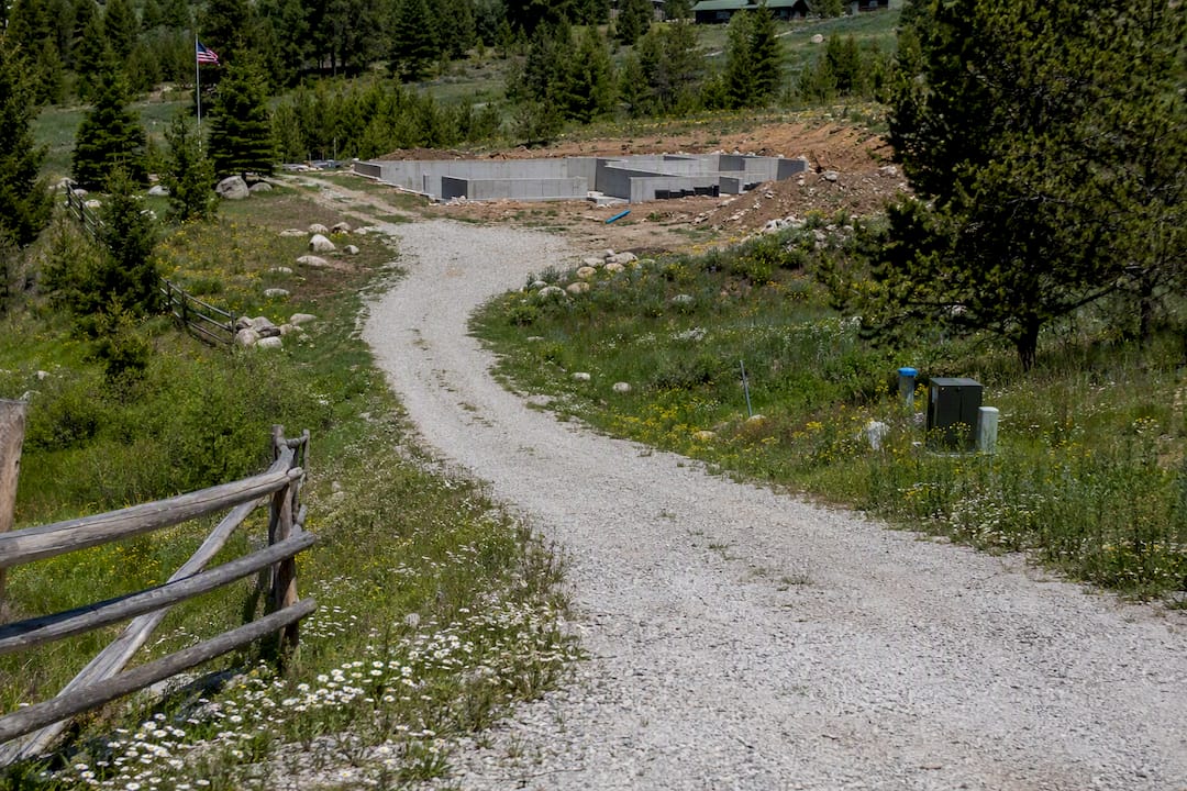 Rural driveway leading to home foundation area