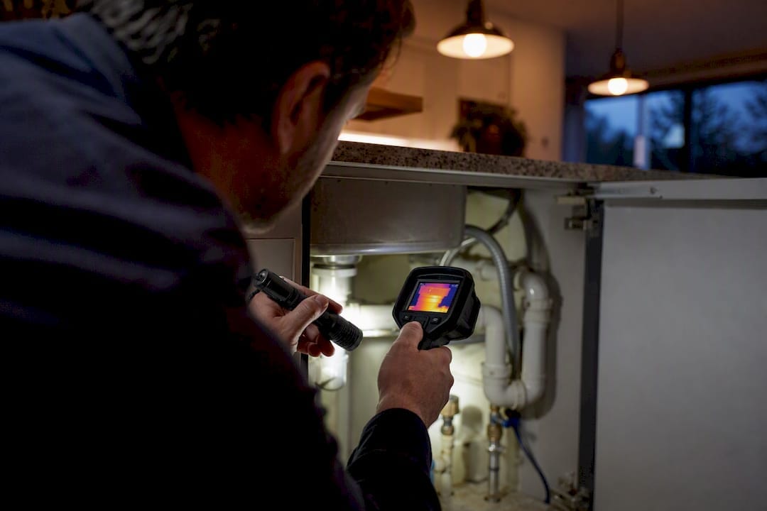 Inspector hands testing electrical panel