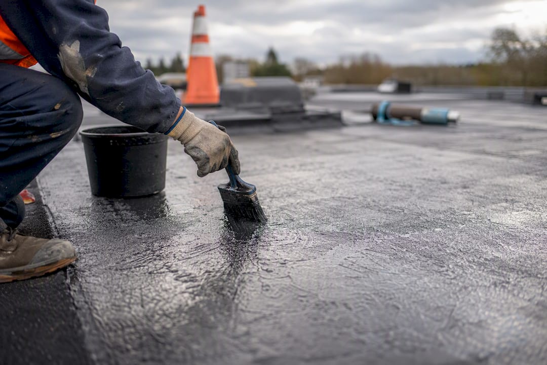 Applying liquid roofing membrane near roof penetrations