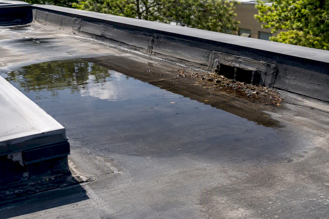 Ponding water on commercial flat roof membrane