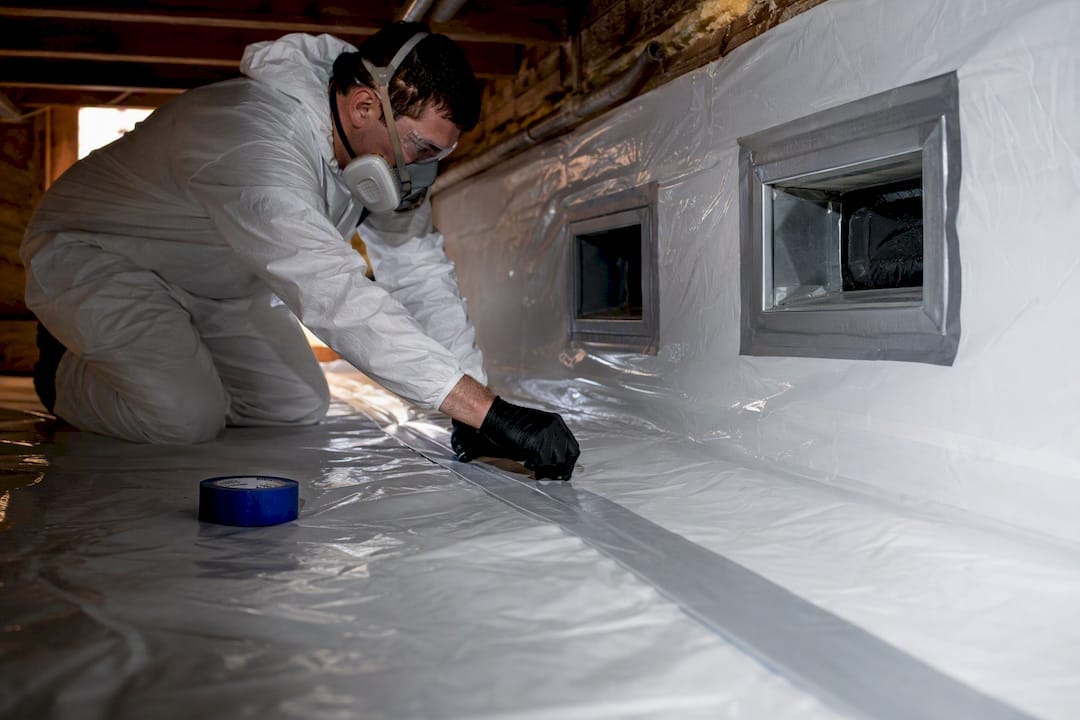 Plastic containment barrier inside crawl space