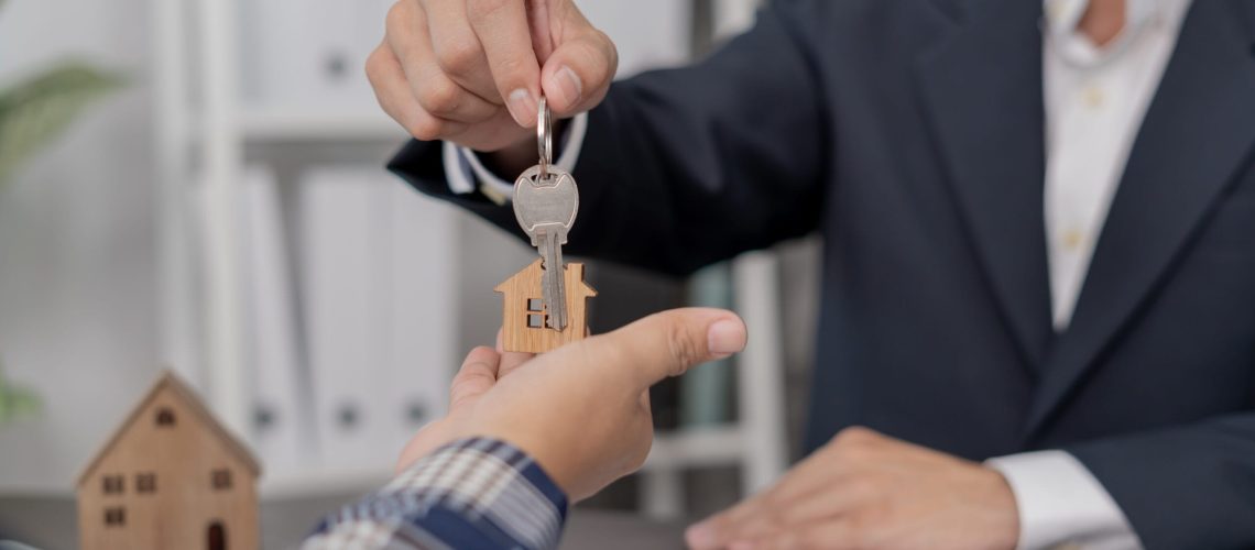 real estate agent olding key for new owner