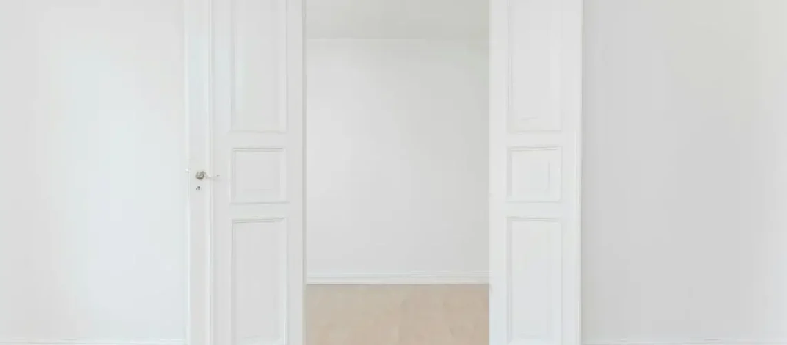 a white room with open doors